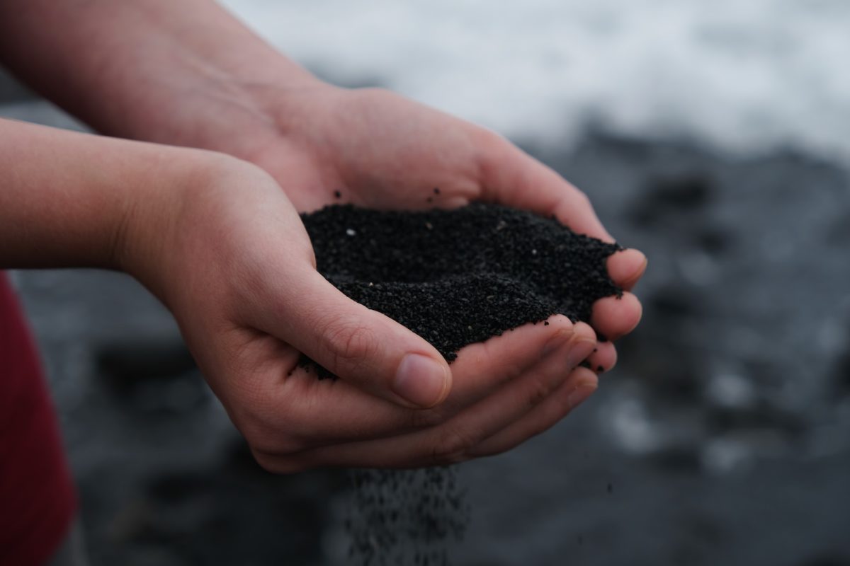 person holding black soil